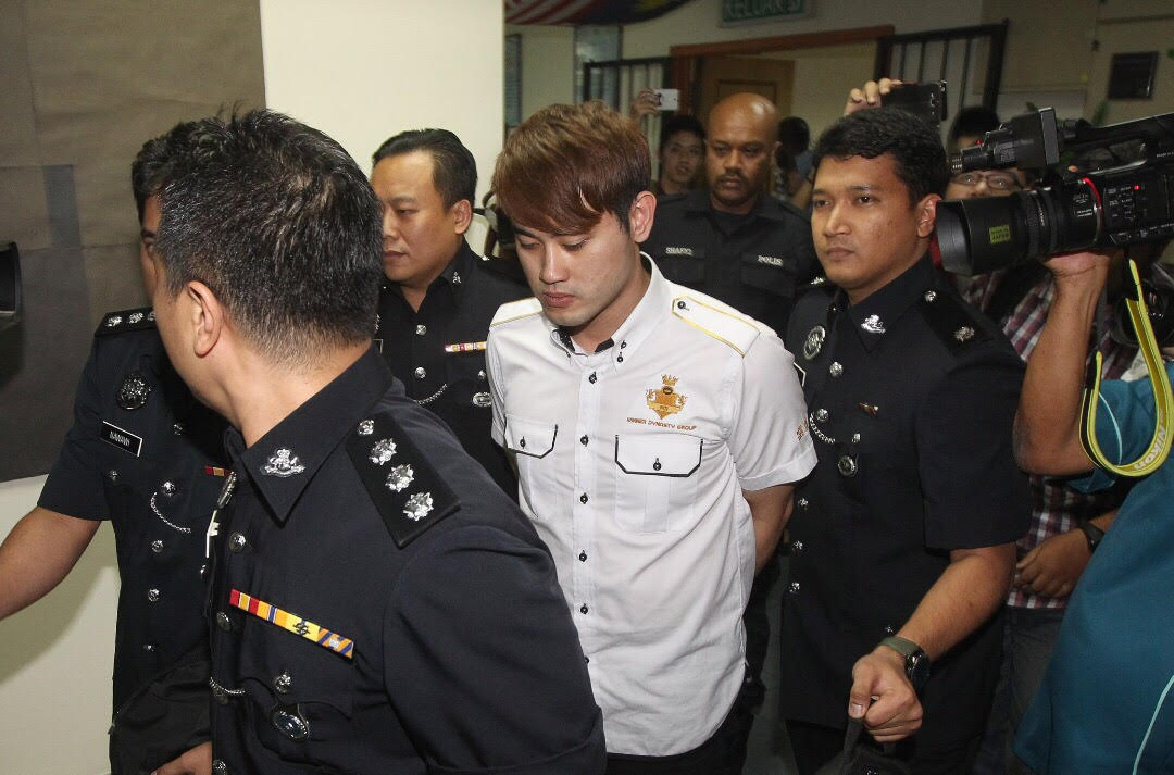 The accused being led by policemen at the Ampang Jaya Magistrates Court today afternoon. u00e2u20acu2022 Picture by Razak Ghazali