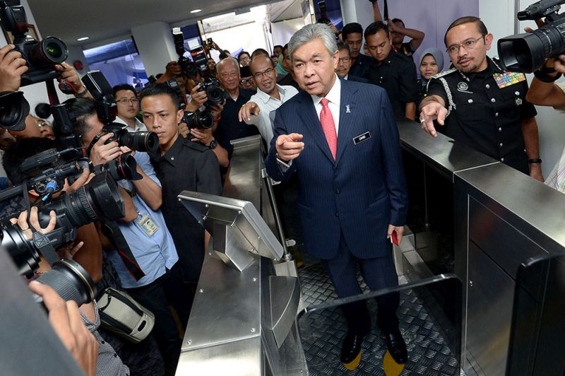 Datuk Seri Dr Ahmad Zahid Hamidi tries the new auto-gate machine with facial recognition technology, December 21, 2017. u00e2u20acu201d Picture by Mukhriz Hazimnn