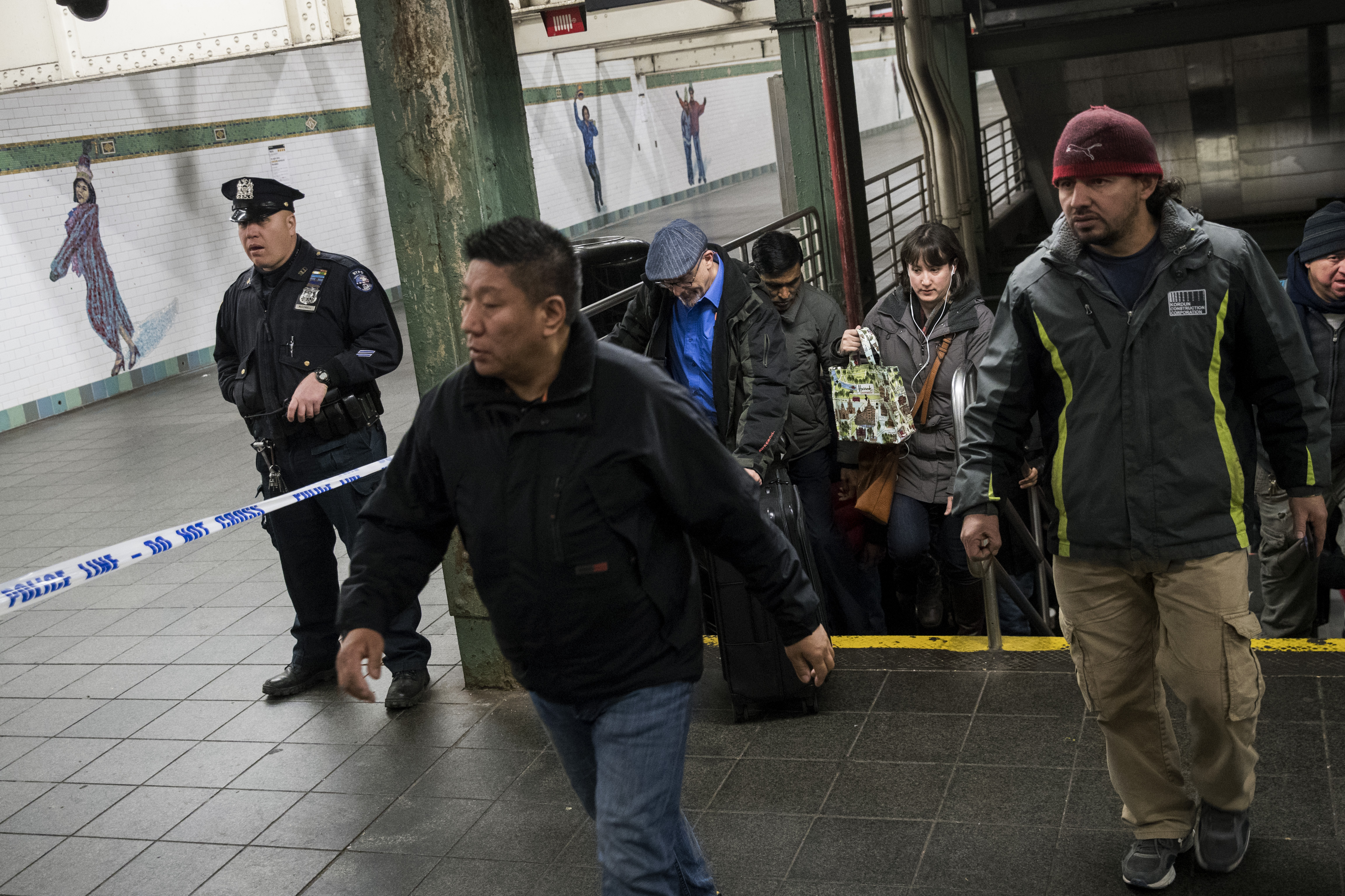 Commuters exit a train as a police officer stands in a closed-off underground walkway at the Times Square subway station to the Port Authority Bus Terminal, December 11, 2017 in New York City. u00e2u20acu201d AFP pic 