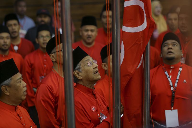 Tun Dr Mahathir Mohamad raises the party flag during Parti Pribumi Bersatu Malaysia first annual general meeting in Shah Alam December 30, 2017. u00e2u20acu2022 Picture by Azneal Ishak