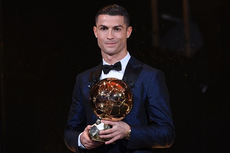 This handout photo released on December 7, 2017 by L'Equipe shows Portugese player Cristiano Ronaldo posing with the 2017 Ballon d'Or France Football trophy in Paris. u00e2u20acu2022 AFP pic