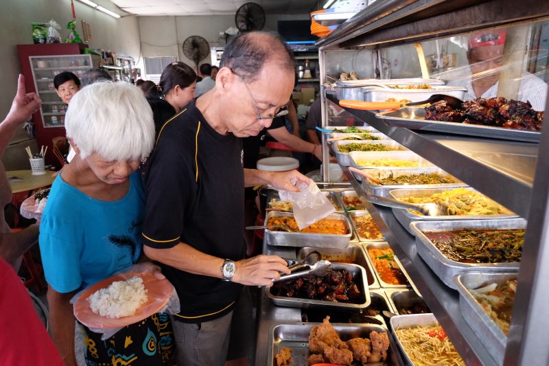 Customers getting free lunch at Soon Lee Coffee Shop along Perak Road in George Town December 26, 2017. u00e2u20acu2022 Picture by KE Ooi
