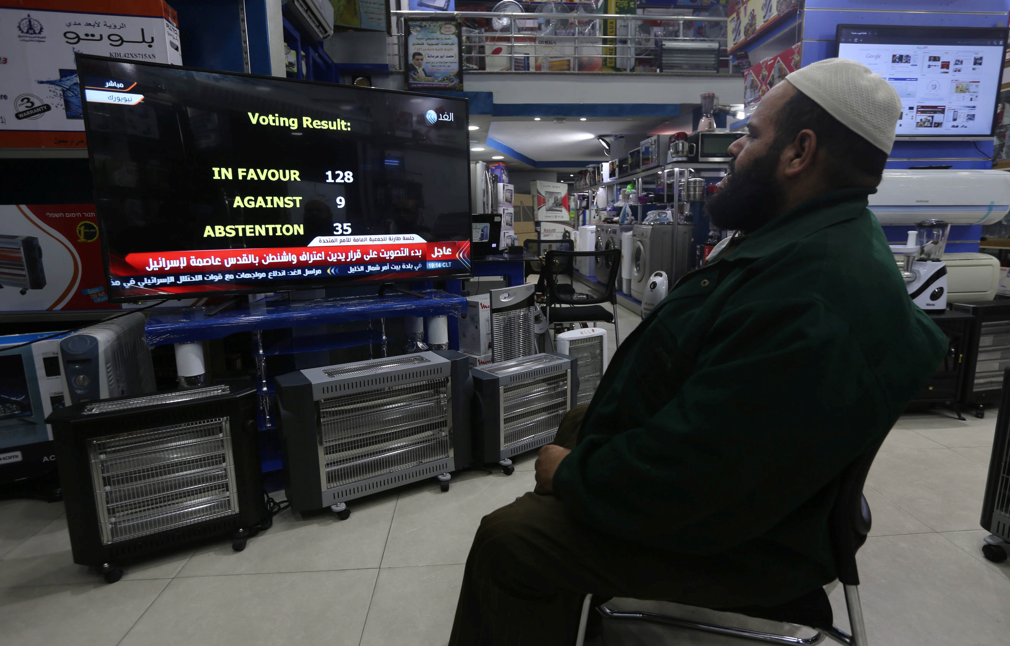 A Palestinian man watches a televised broadcast of the UN General Assembly vote at an electrical appliances store in Rafah in the southern Gaza Strip December 21, 2017. u00e2u20acu201d Reuters pic