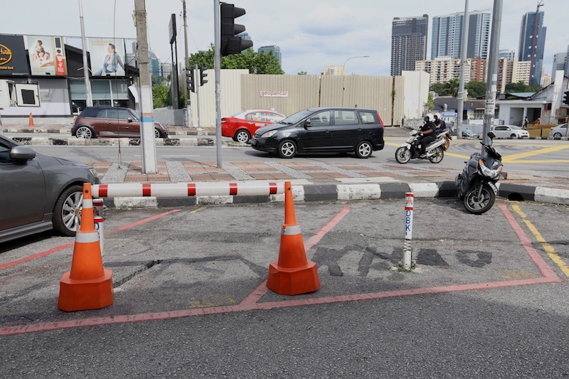 Cones are placed at the reserved parking bays to prevent the public from parking in those spots. u00e2u20acu201d Picture by u00c2u00a0Zuraneeza Zulkifli