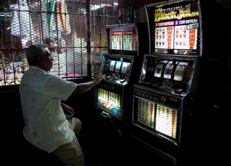 A man plays on a slot machine inside a game room at the Oriental Market in Managua, Nicaragua February 27, 2018. u00e2u20acu201d Reuters pic