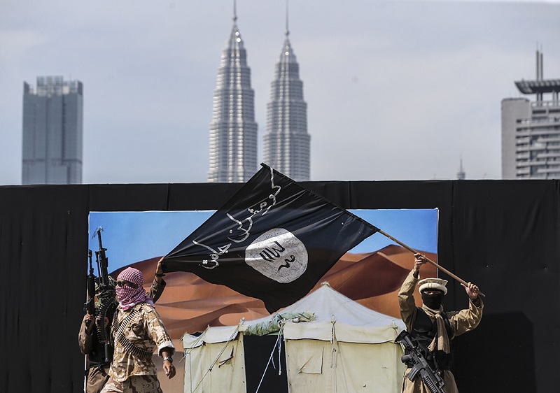 Members of The Royal Malaysian Police take part in a demonstration showing a mock terrorist attack during the 211th National Day celebration at Pulapol in Kuala Lumpur March 25, 2018. u00e2u20acu201d Picture by Azneal Ishak