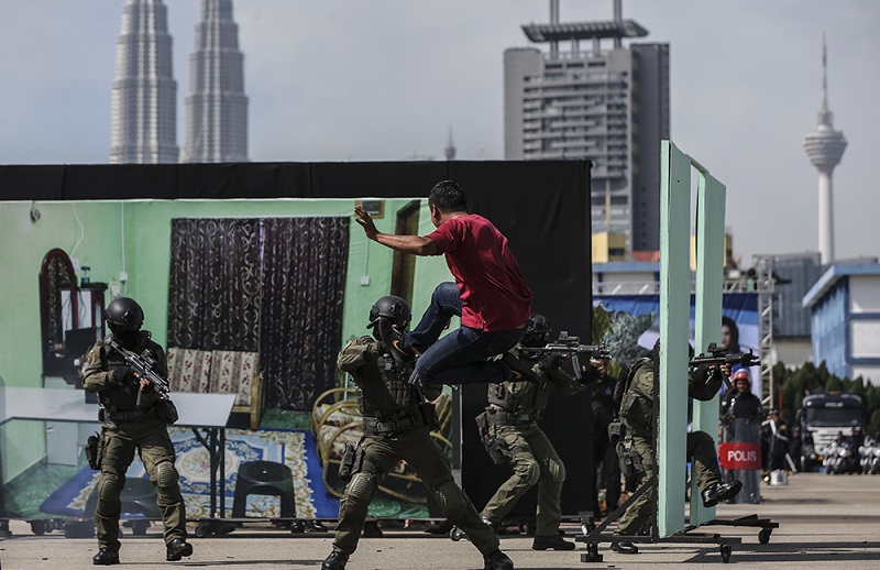 Members of The Royal Malaysian Police take part in a demonstration showing a mock terrorist attack during the 211th National Day celebration at Pulapol in Kuala Lumpur March 25, 2018. u00e2u20acu201d Picture by Azneal Ishak