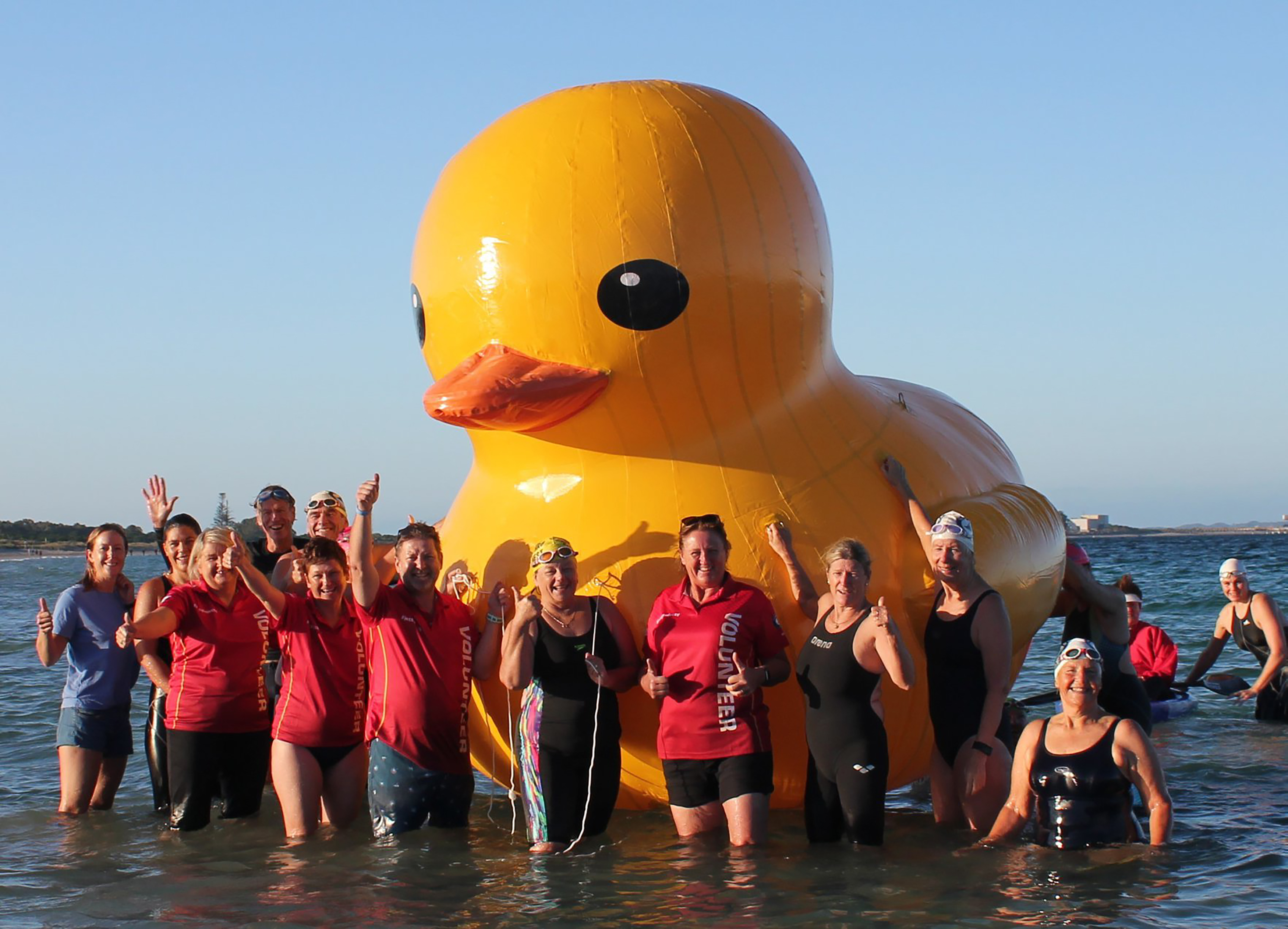 This undated handout photo supplied on March 18, 2018 by Perth's Cockburn Masters Swimming Club shows swimmers posing with a giant inflatable duck they named Daphne in Perth. u00e2u20acu201d AFP pic