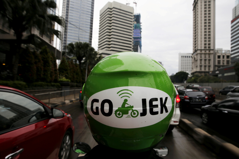 A Gojek driver rides his motorcycle through a business district street in Jakarta June 9, 2015. u00e2u20acu201d Reuters pic