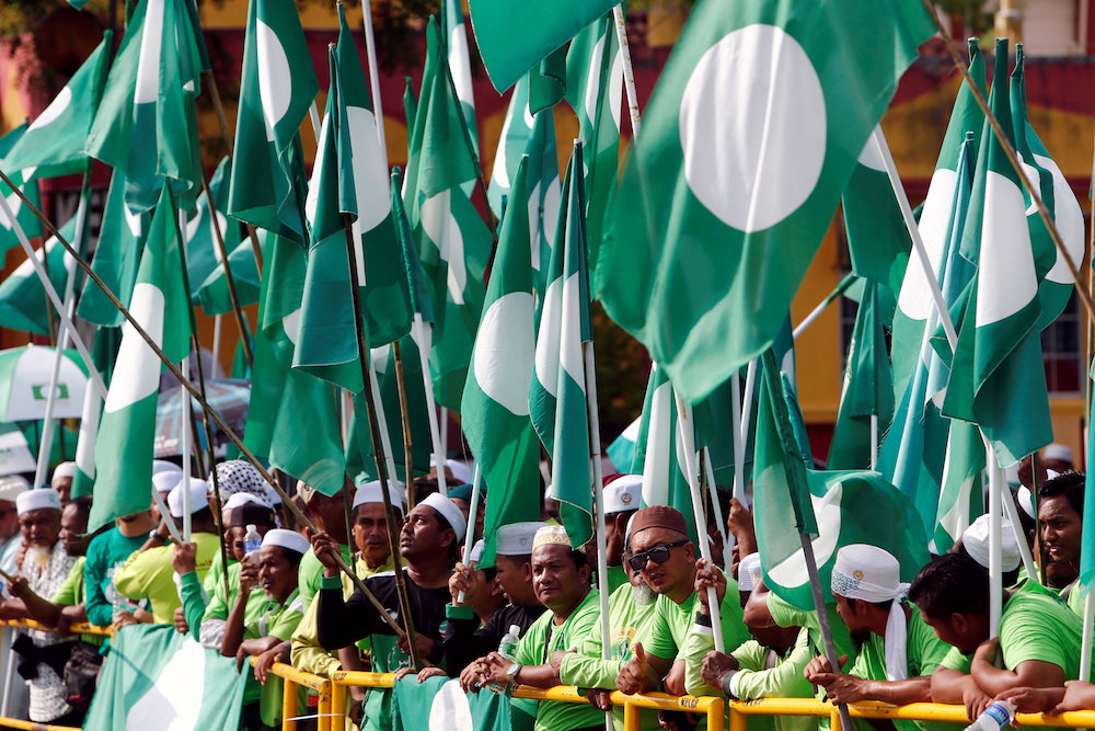 PAS supporters hold their party flag on Nomination Day in Langkawi April 28, 2018. u00e2u20acu201d Reuters pic
