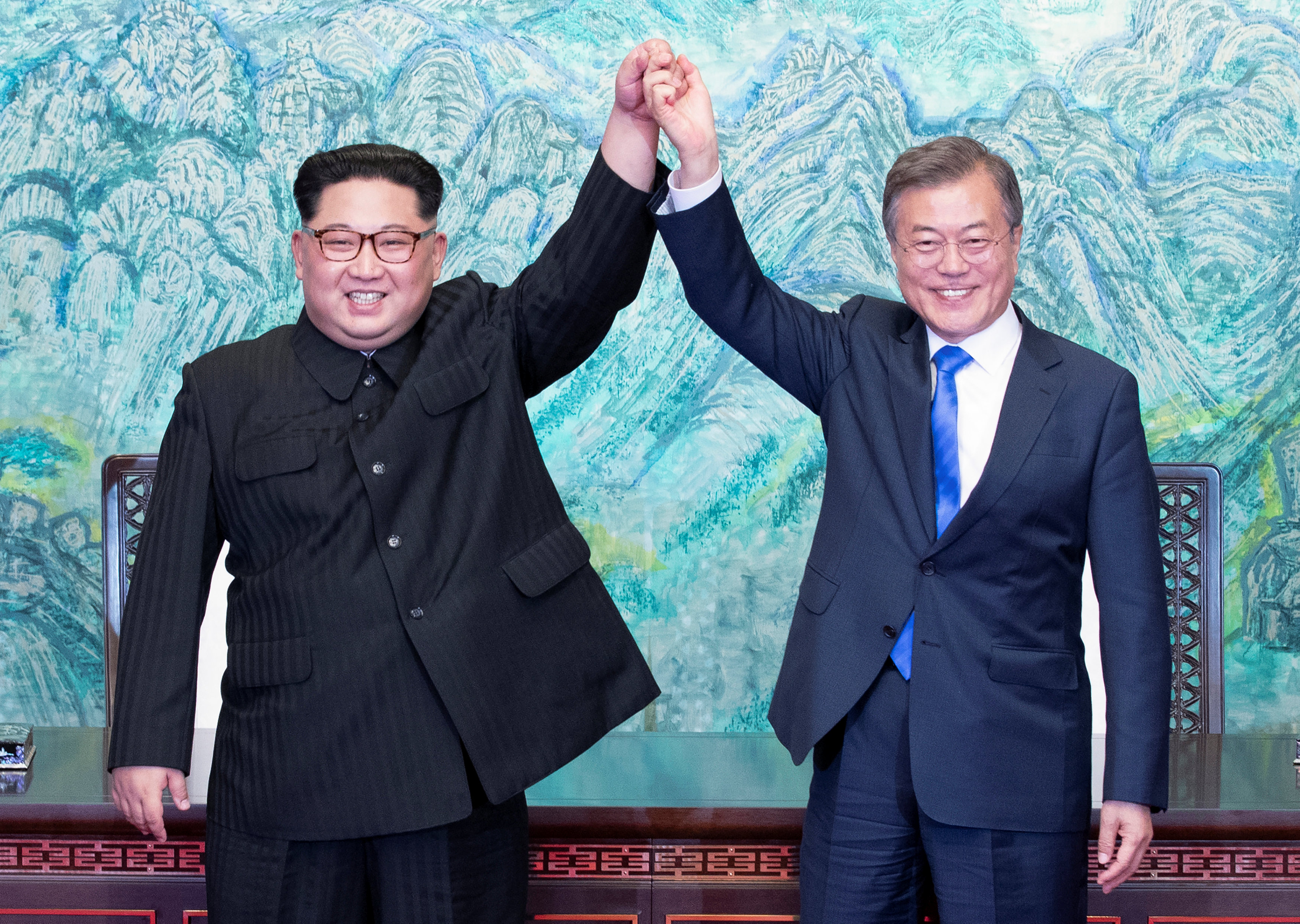 South Korean President Moon Jae-in and North Korean leader Kim Jong-un raise their hands at the truce village of Panmunjom inside the demilitarised zone separating the two Koreas, April 27, 2018. u00e2u20acu201d Reuters pic