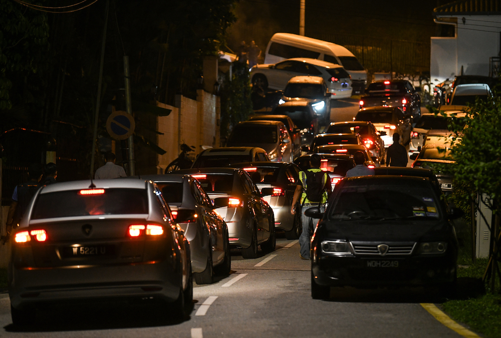 Police cars enter the road leading to former prime minister Datuk Seri Najib Razaku00e2u20acu2122s residence in Kuala Lumpur May 16, 2018. u00e2u20acu201d AFP pic