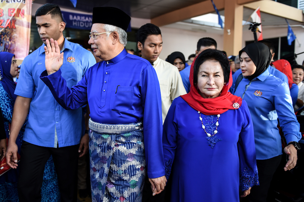 Datuk Seri Najib Razak and his wife Datin Seri Rosmah Mansor wave to their supporters as they arrive at the nomination centre to hand over election documents in Pekan April 28, 2018. u00e2u20acu201d AFP pic