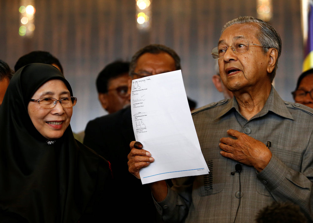 Tun Dr Mahathir Mohamad holds up a document with the signatures of alliance party leaders naming him as the prime minister during a news conference in Petaling Jaya May 10, 2018. u00e2u20acu201d Reuters pic
