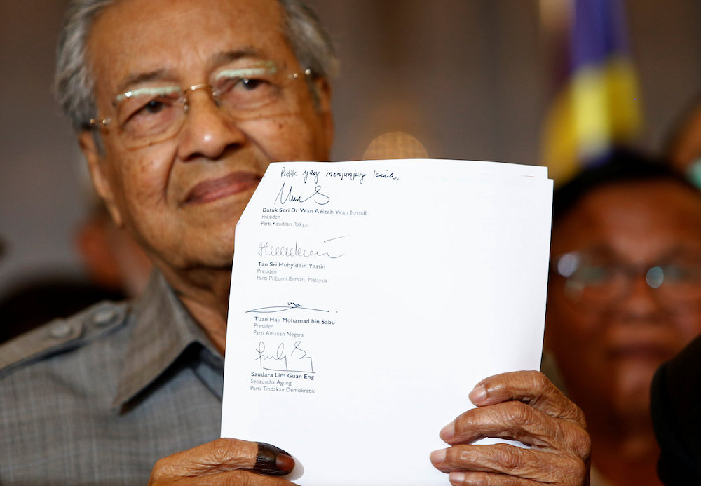Mahathir Mohamad holds up a document with the signatures of alliance party leaders naming him as the prime minister during a news conference following the general election in Petaling Jaya May 10, 2018. u00e2u20acu201d Reuters pic