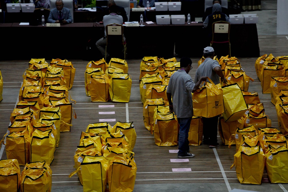 Election Commission personnel arrange ballot boxes at the vote tallying centre at Maktab Mahmud Hall in Alor Setar May 9, 2018. u00e2u20acu201d Picture by Sayuti Zainudin