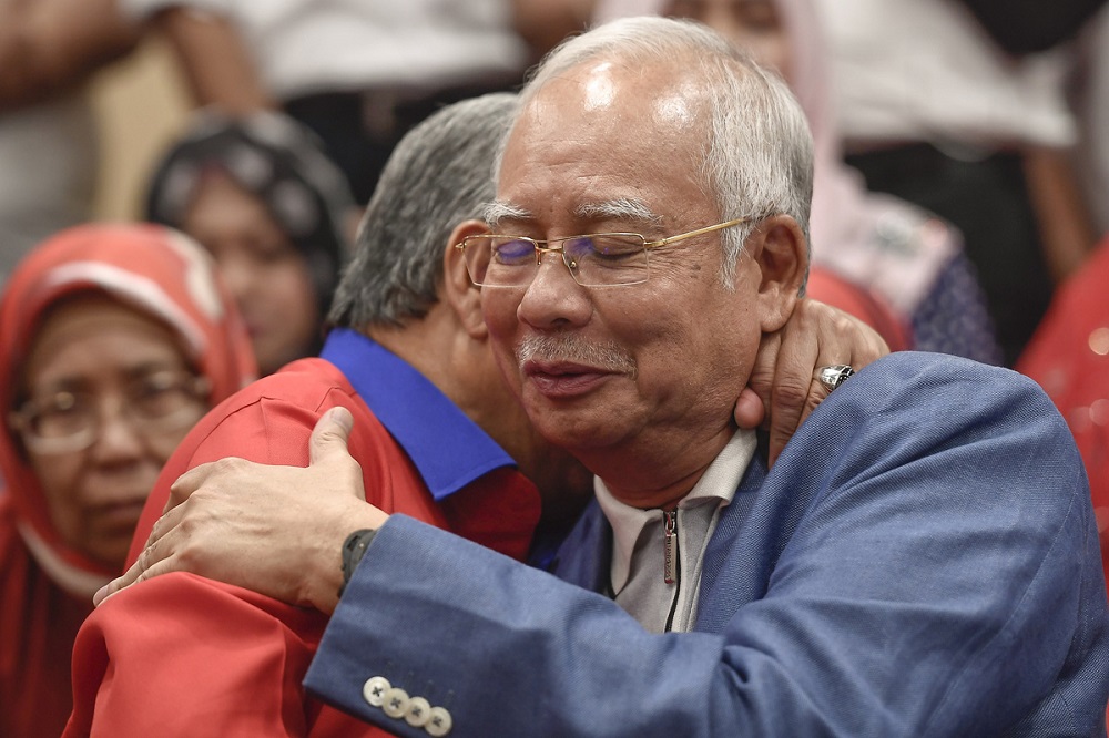 Datuk Seri Zahid Hamidi hugs Datuk Seri Najib Razak during a press conference in Kuala Lumpur May 12, 2018. u00e2u20acu201d Picture by Mukhriz Hazim