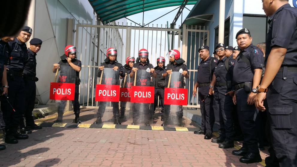 Police officers, including the light strike force, swoop in to control the mob outside the Sultan Abdul Aziz Shah Airport in Subang Jaya May 12, 2018. u00e2u20acu201d Picture by May Robertson