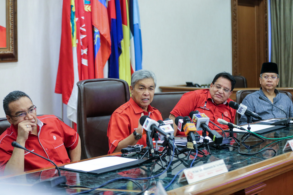 Datuk Seri Zahid Hamidi, flanked by Datuk Seri Hishammuddin Hussein and Datuk Seri Tengku Adnan Mansor, speaks to media after an Umno supreme council meeting in Kuala Lumpur May 22, 2018. u00e2u20acu201d Picture by Ahmad Zamzahuri
