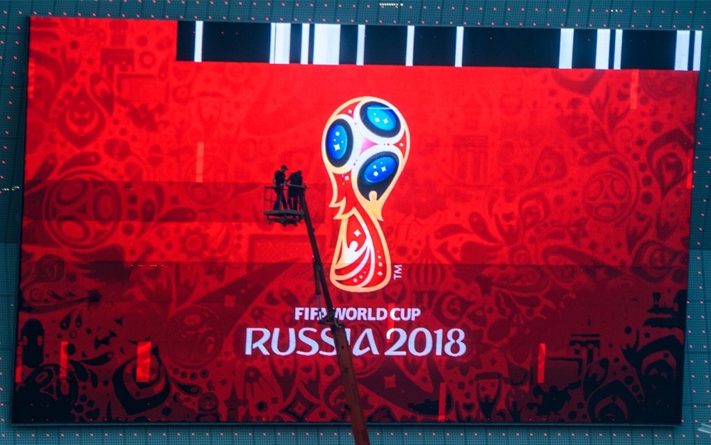 Workers fix a giant screen featuring the Russian Fifa World Cup logo, mounted outside Rostov Arena in the southern Russian city of Rostov-on-Don May 12, 2018. u00e2u20acu201d AFP pic
