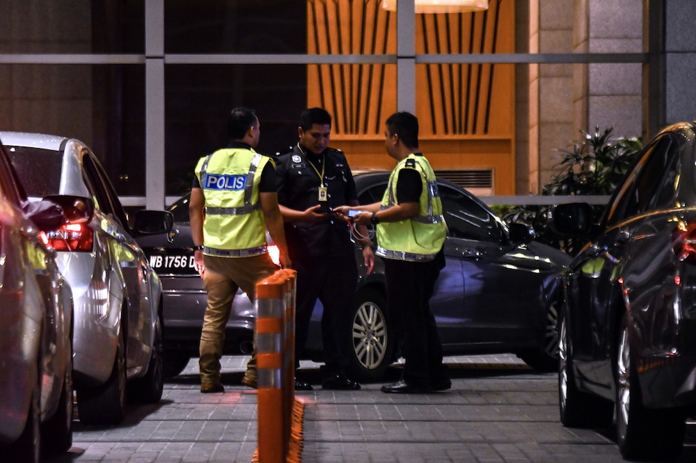 Police are seen in the lobby of luxury apartment building Pavilion Residences on Jalan Raja Chulan in Kuala Lumpur May 17, 2018. u00e2u20acu201d Bernama pic