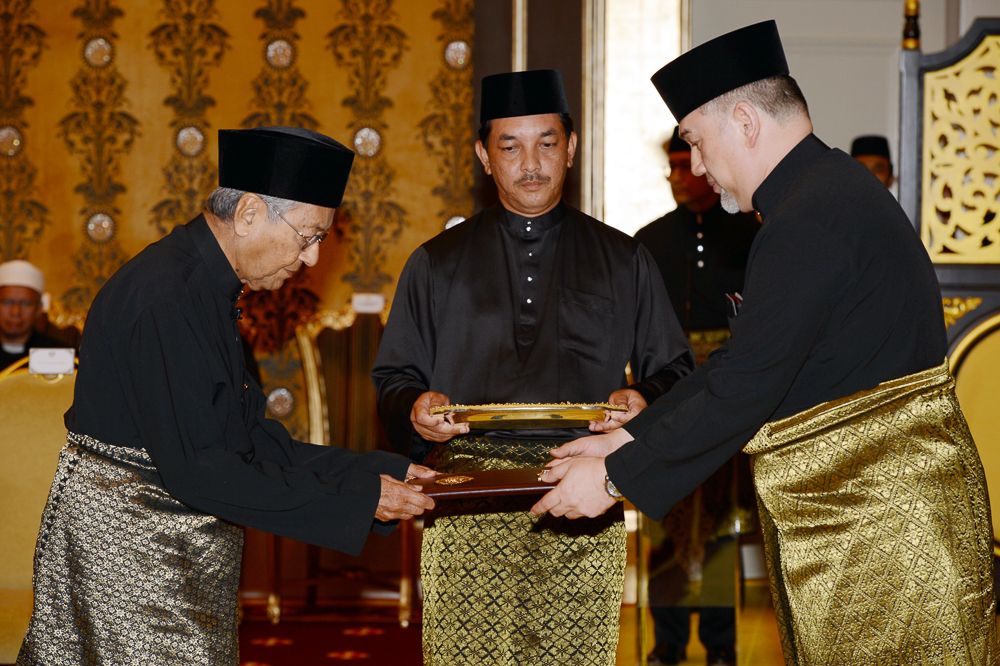 Yang di-Pertuan Agong Sultan Muhammad V presenting the Instruments of Appointment as Prime Minister to Tun Dr Mahathir Mohamad at Istana Negara, May 10, 2018. u00e2u20acu201d Bernama pic