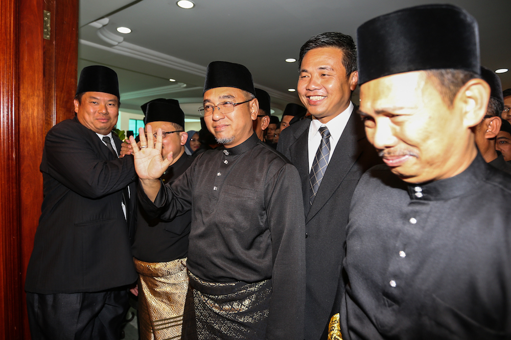 Adly Zahari (centre) arrives to be sworn in as the 11th chief minister of Melaka in Melaka May 11, 2018. u00e2u20acu201d Picture by Ahmad Zamzahuri