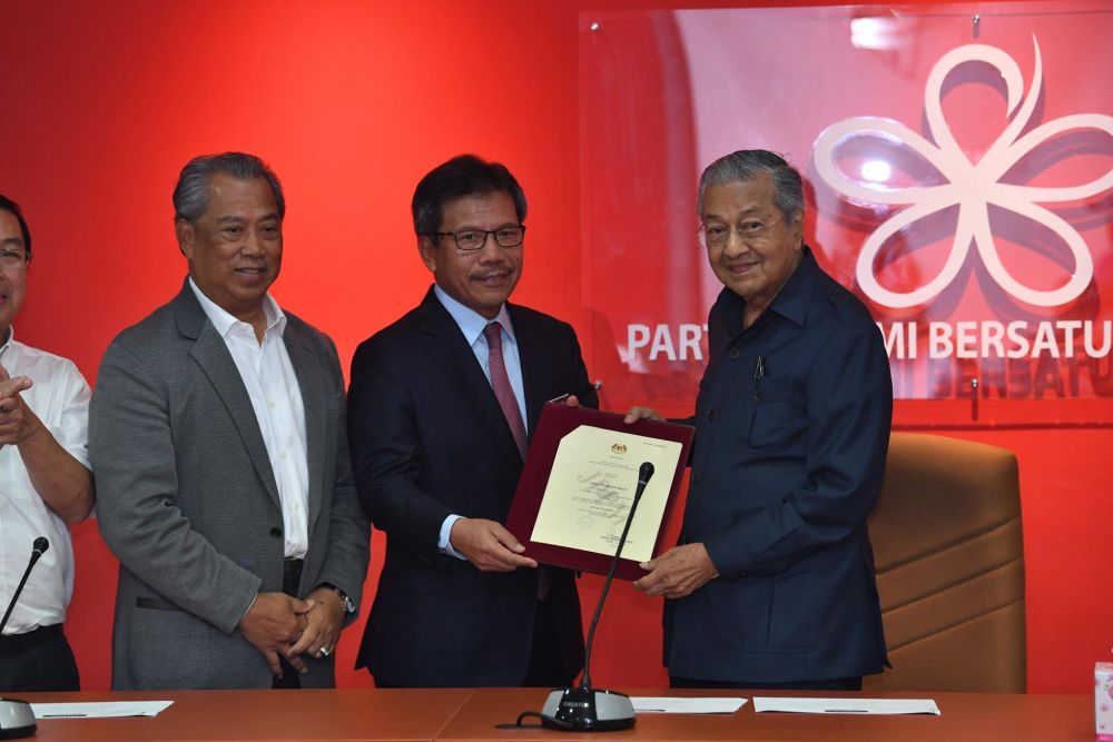 Home Ministry secretary-general Datuk Seri Alwi Ibrahim hands over the certificate of registration to Prime Minister Tun Dr Mahathir Mohamad (right), May 17, 2018. u00e2u20acu2022 Picture via Facebook/Pakatan Hrapan