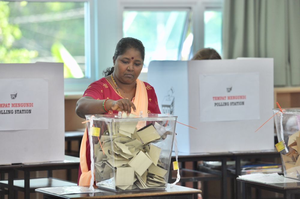 A voter drops her ballot into the box at the SRJK (C) Pai Chai polling centre in Batu Ferigghi May 9, 2018. u00e2u20acu2022 Picture by KE Ooi