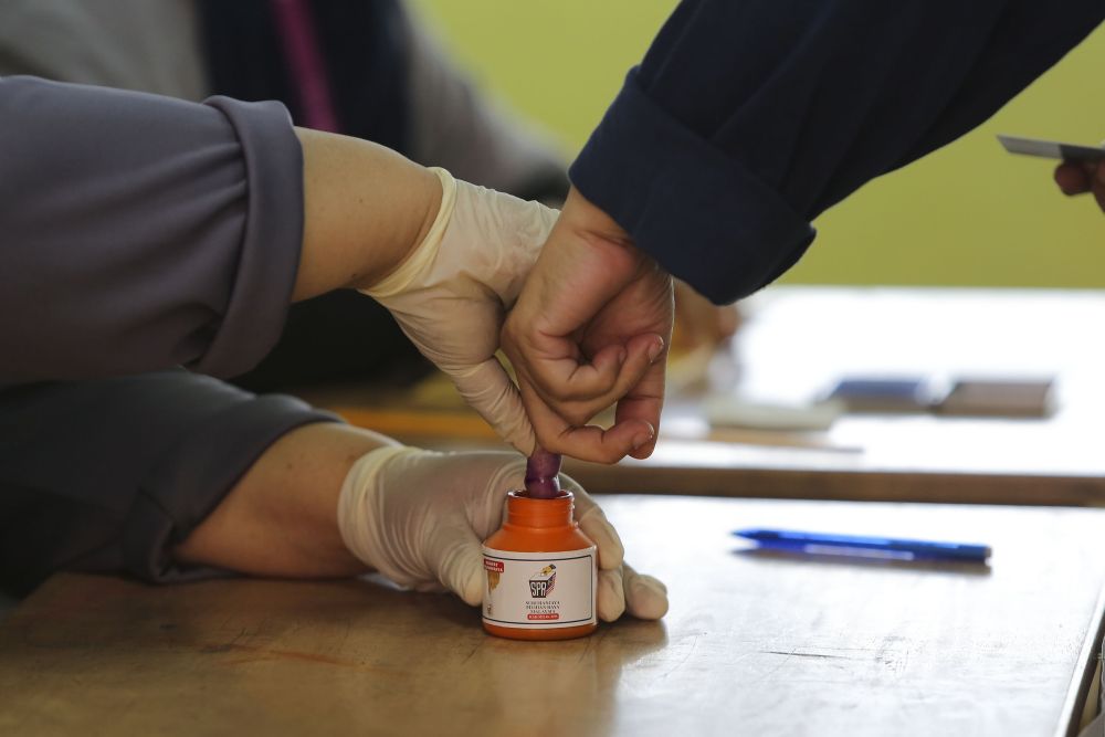 A voter gets her finger marked with indellible ink before she casts her ballot at a polling centre in Kuala Lumpur May 9, 2018. u00e2u20acu2022 Picture by Yusof Mat Isa