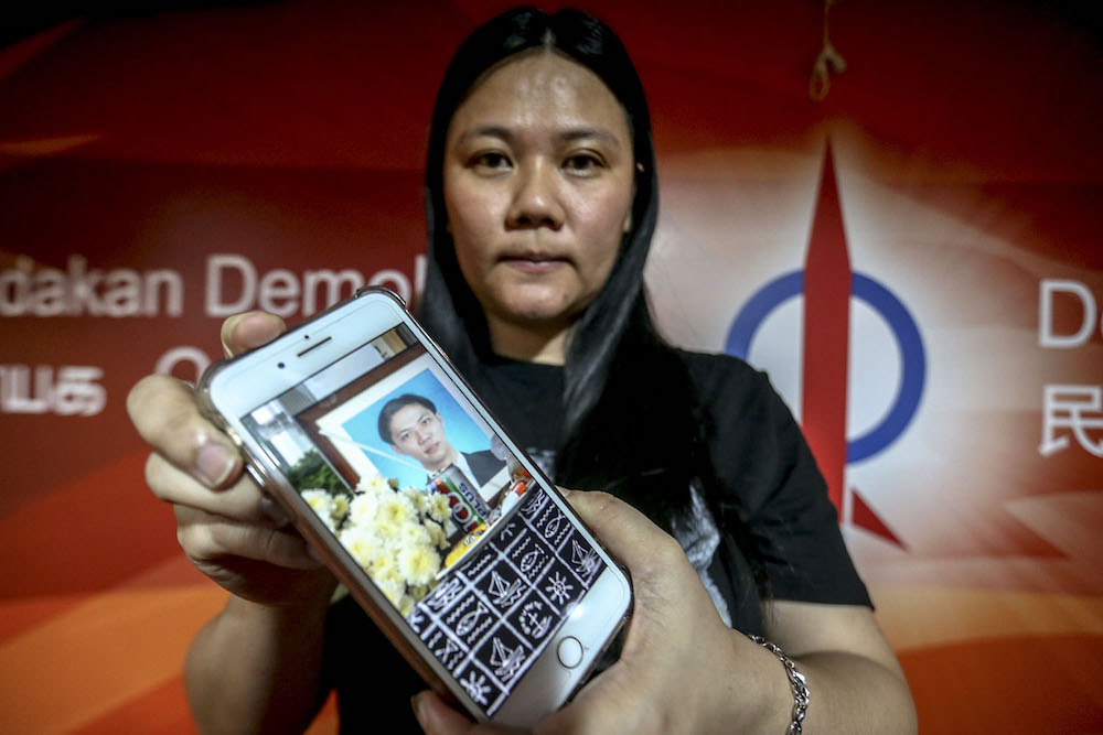 Teoh Lee Lan shows a picture of her brother Teoh Beng Hock on her phone after a press conference in Petaling Jaya June 20, 2018. u00e2u20acu201d Picture by Hari Anggara