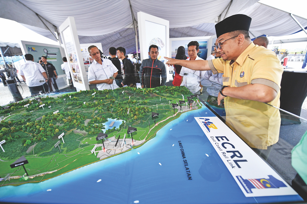 A man looks at a map of the East Coast Rail Link (ECRL) during a ground-breaking ceremony in Tunjong, Kota Baru, April 11, 2018. u00e2u20acu201d Bernama pic