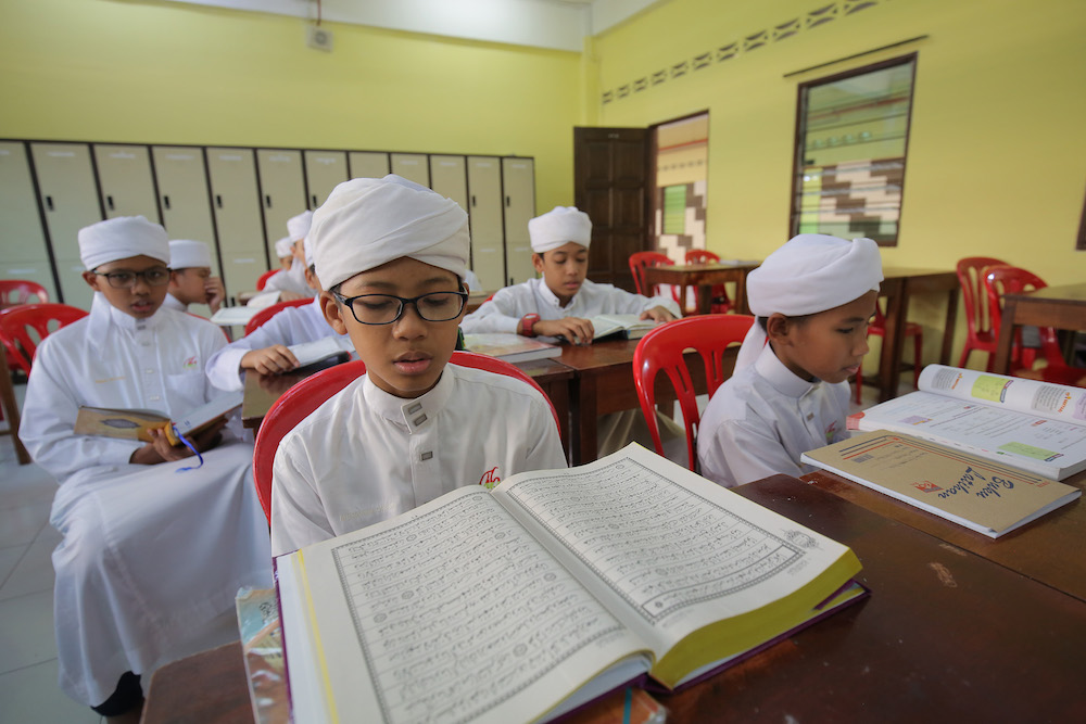 Students attending class at the Tahfiz Darul Barakah centre. u00e2u20acu201d Picture by Marcus Pheong