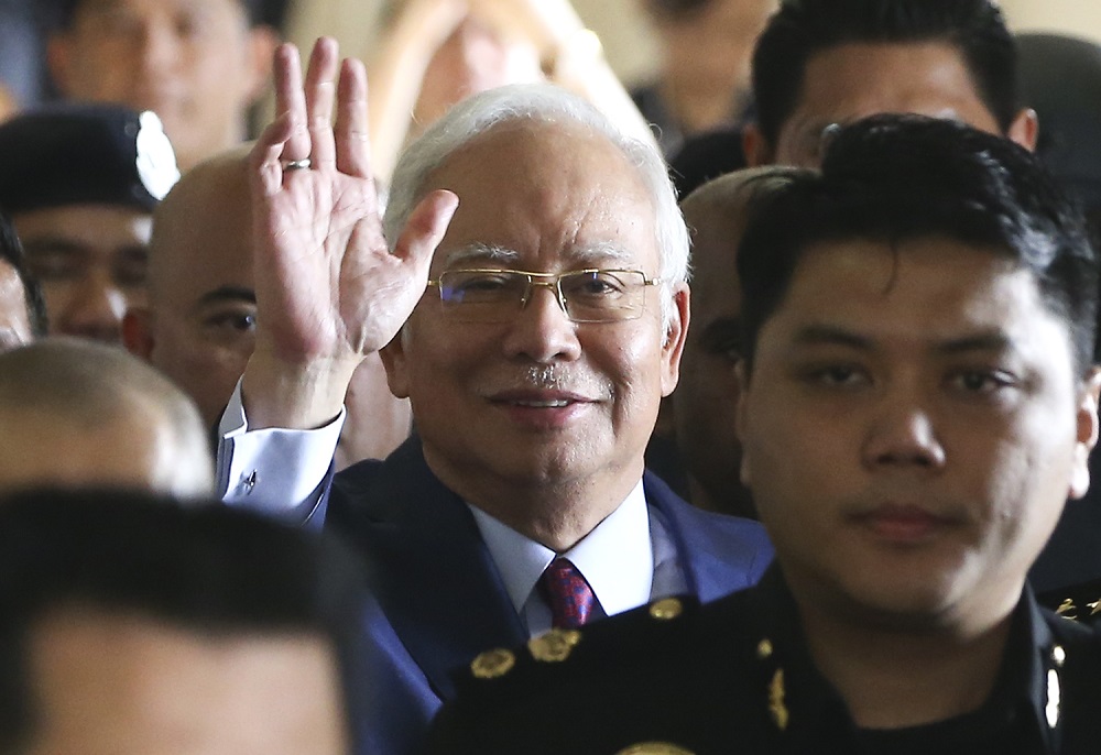 Former prime minister Datuk Seri Najib Razak wave at the media as he enters Criminal High Court 3 at the Kuala Lumpur Courts Complex July 4, 2018. u00e2u20acu201d Picture by Azneal Ishak 