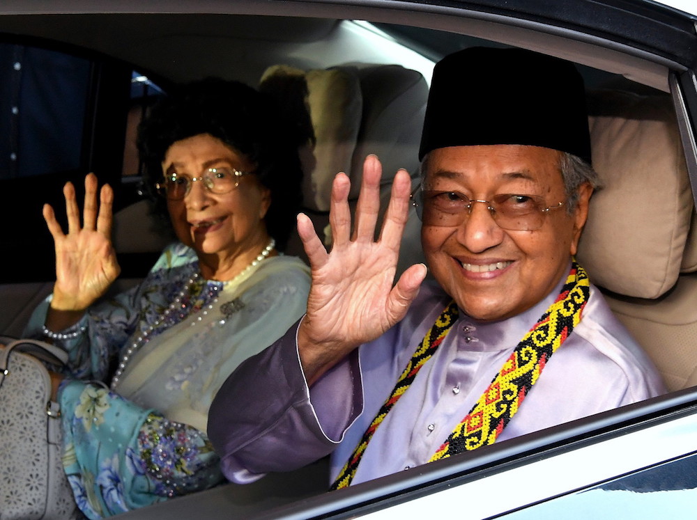 Tun Dr Mahathir Mohamad and Tun Dr Siti Hasmah Mohd Ali wave after arriving at Kuching International Airport July 14, 2018. u00e2u20acu201d Bernama pic