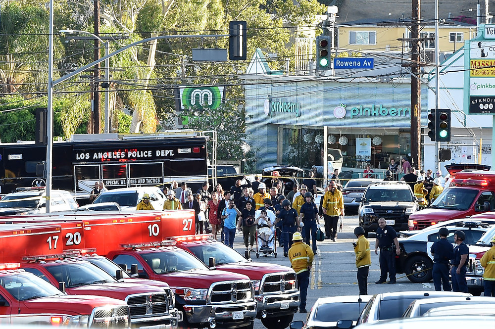 Police officers and members of the Los Angeles Fire Department escort a woman on a stretcher after a suspect barricaded inside a supermarket in Los Angeles July 21, 2018. u00e2u20acu201d AFP pic