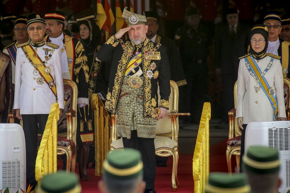 Yang di-Pertuan Agong Sultan Muhammad V (centre) salutes honour guards during the opening of the Parliament sitting in Kuala Lumpur July 17, 2018. u00e2u20acu2022 Picture by Yusof Mat Isa