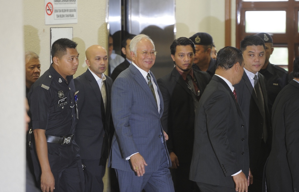 Former prime minister Datuk Seri Najib Razak smiles as he arrives at the Kuala Lumpur Court Complex, August 8, 2018. u00e2u20acu201d Picture by Shafwan Zaidon