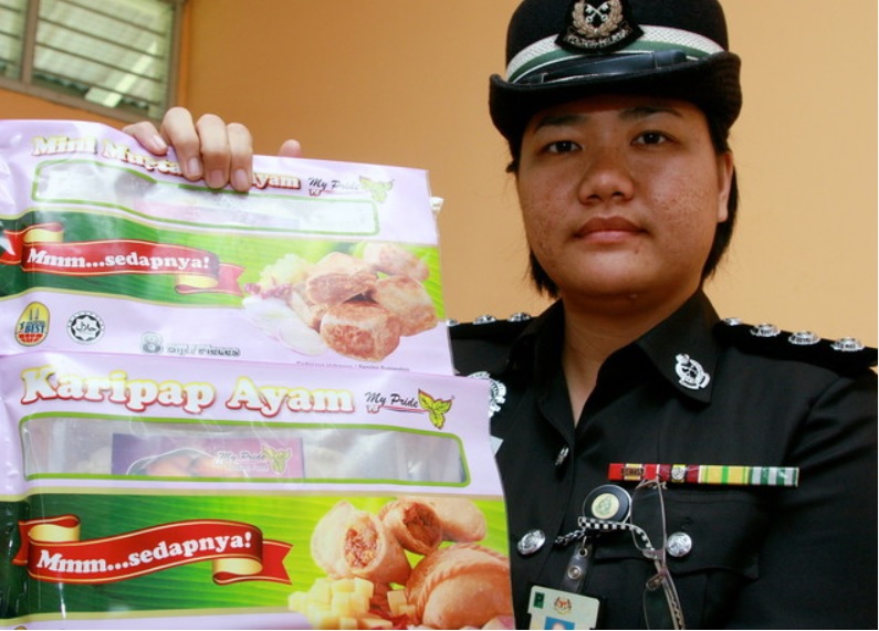 一名大马女警在展示“My Pride”的冷冻食品。-马新社-