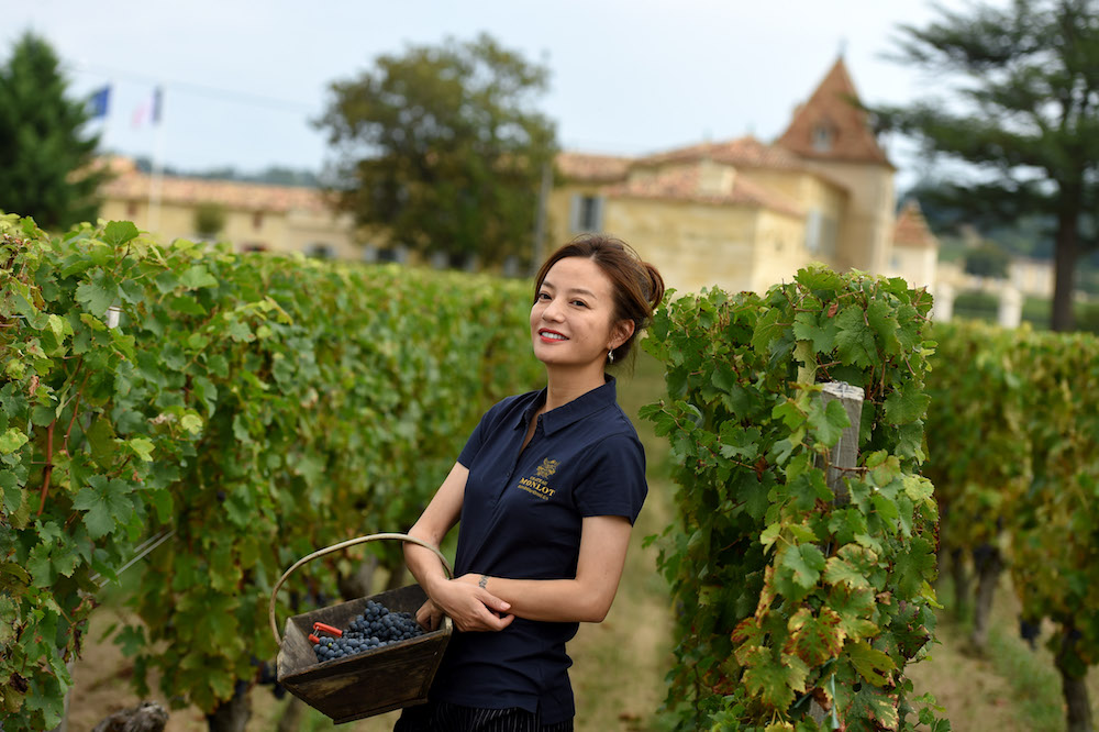 Zhao Wei poses in Saint-Hippolyte, southwestern France, in her vineyard of Chateau Monlot, which is being harvested, on September 18, 2018. u00e2u20acu201d AFP pic