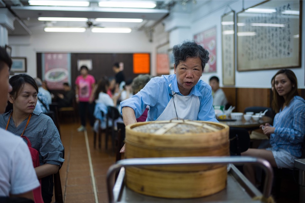 Diners watch as a trolley lady passes them with bamboo steamers containing dim sum dishes at the Lin Heung Tea House in Hong Kong. u00e2u20acu201d AFP pic