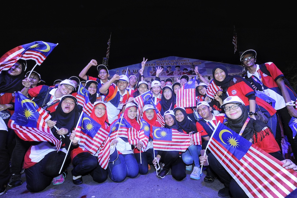 Participants wave flags during 2018 Malaysia Day Celebrations at Padang Merdeka in Kota Kinabalu September 16, 2018. u00e2u20acu201d Picture by Shafwan Zaidon