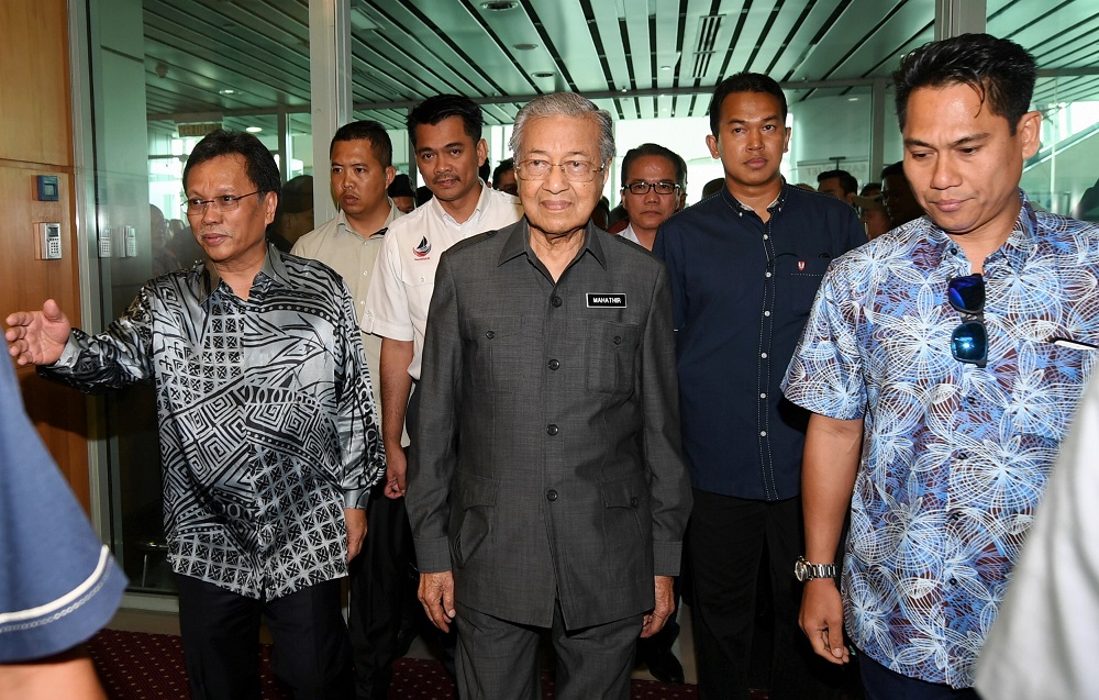 Prime Minister Tun Dr Mahathir Mohamad is greeted by Sabah Chief Minister Datuk Seri Mohd Shafie Apdal (left) upon his arrival at the Kota Kinabalu Airport September 16, 2018. u00e2u20acu201d Bernama pic
