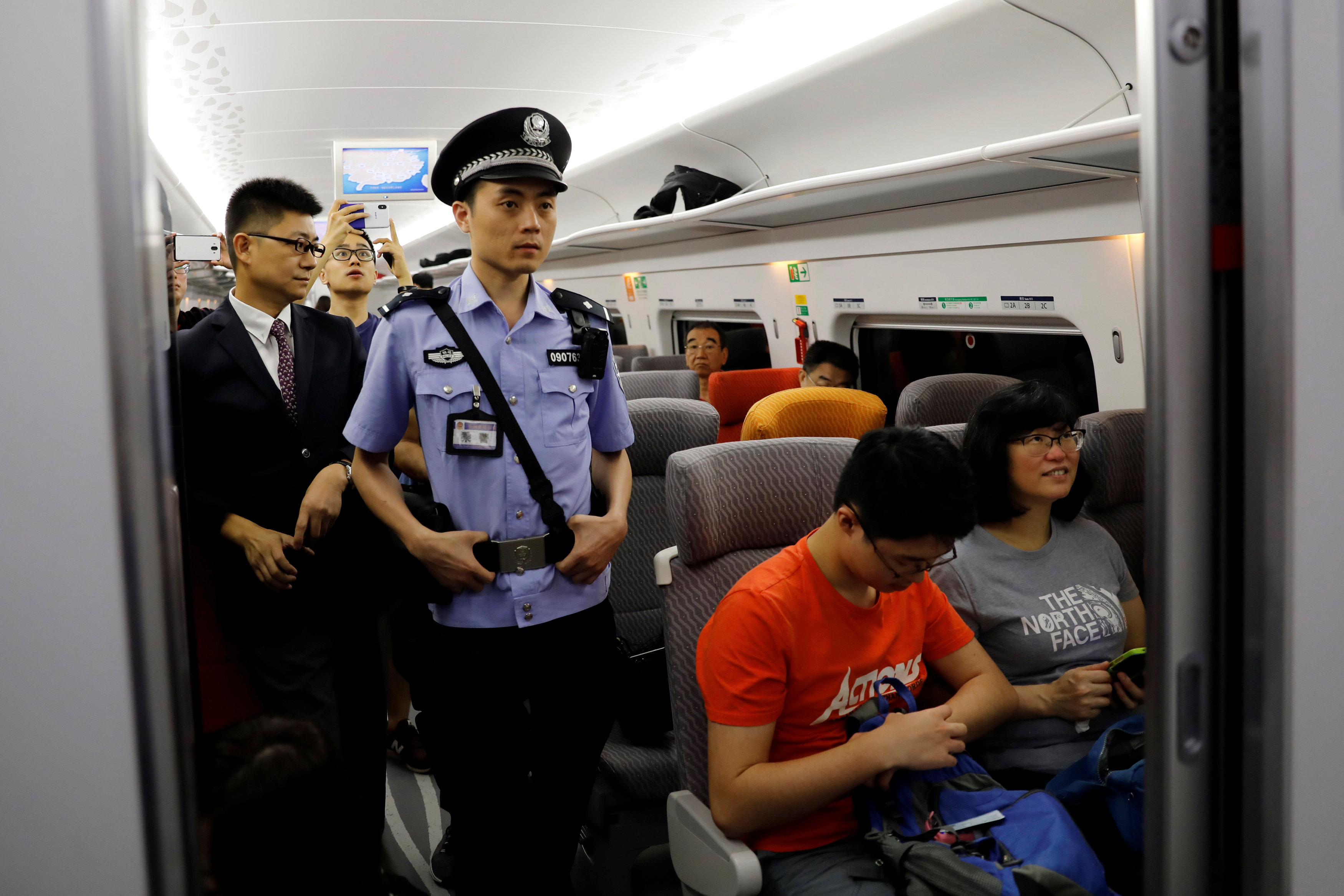 周日投入服务的广深港高铁列车行驶期间，有公安在列车上巡逻。-路透社-