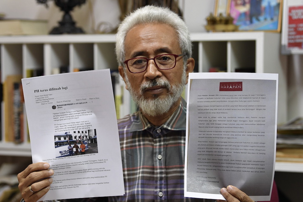 Terengganu Pakatan Harapan chairman Senator Datuk Raja Kamarul Bahrin Shah holds examples of the fake claims during a press conference in Kuala Terengganu September 10, 2018. u00e2u20acu201d Bernama pic