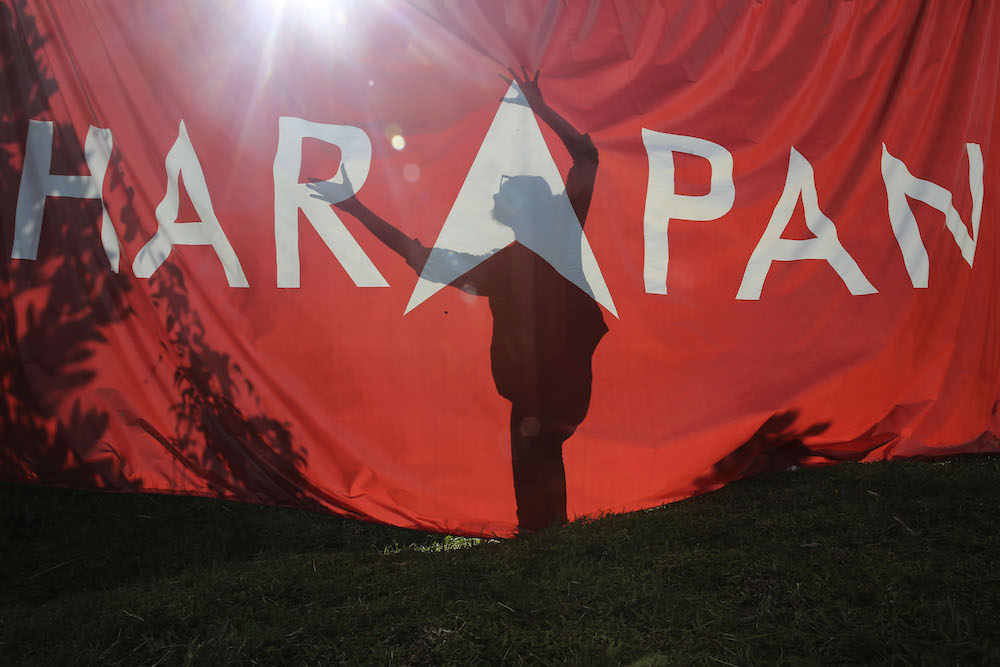 The shadow of a campaign worker is seen against a Pakatan Harapan flag at Pasir Panjang in Port Dickson October 11, 2018. u00e2u20acu201d Picture by Yusof Mat Isa