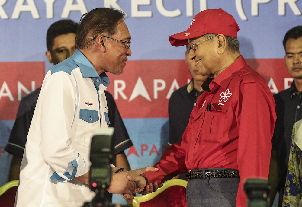 Datuk Seri Anwar Ibrahim and Tun Dr Mahathir Mohamad shake hands during the Ceramah Mega in Port Dickson October 8, 2018. u00e2u20acu201d Picture by Azneal Ishak