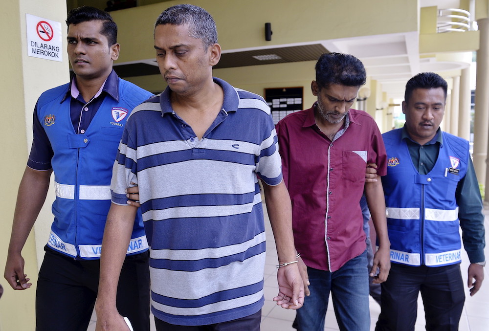 K. Ganesh (2nd right) and A. Mohanraj (2nd left) leave the Selayang Sessions Court October 16, 2018. u00e2u20acu201d Bernama pic