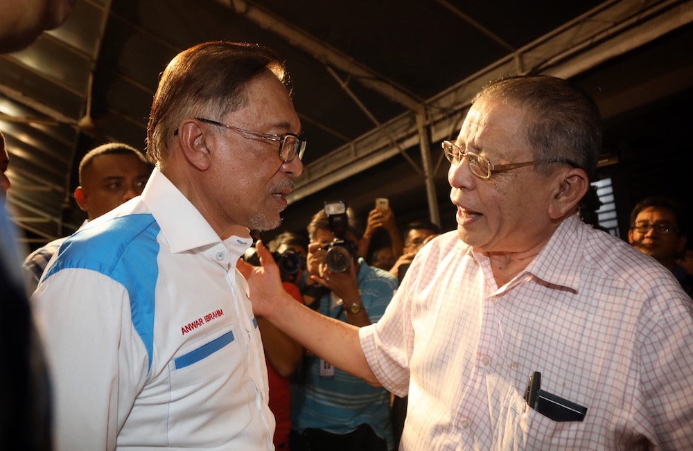 Datuk Seri Anwar Ibrahim and Lim Kit Siang greet each other at a by-election rally in Lukut, Port Dickson October 10, 2018. u00e2u20acu201d TODAY pic