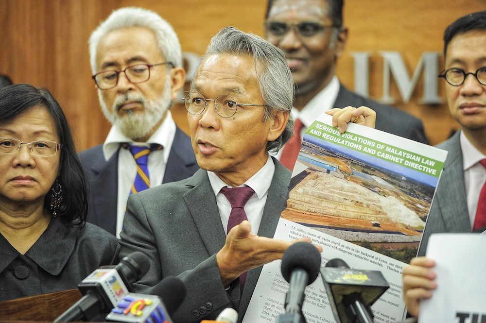 Wong Tuck showing pictures of the Lynas construction site during a press conference in the Parliament building, December 5, 2018. u00e2u20acu201d Picture by Shafwan Zaidon